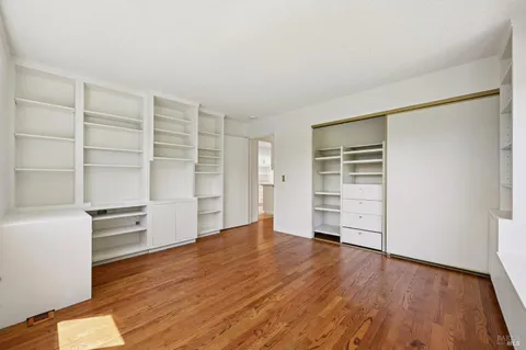 an empty room with large windows and garden view