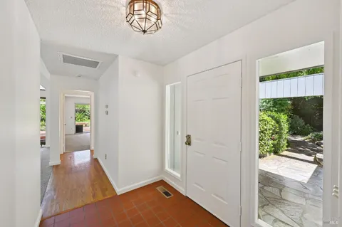 a view of an empty room with a fireplace and a window