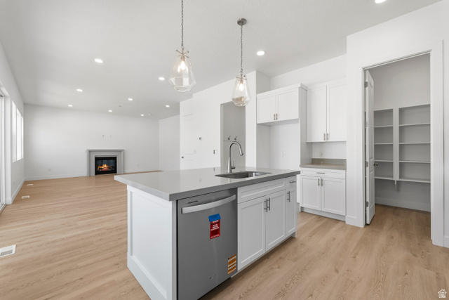 58 South Crimson Way, Unit 306 Mapleton, UT 84664 - Photo 12 of 24 Contemporary kitchen island featuring a stainless steel undermount sink, integrated dishwasher, and pendant lighting
