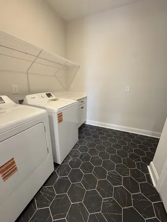 an empty room with a ceiling fan and windows