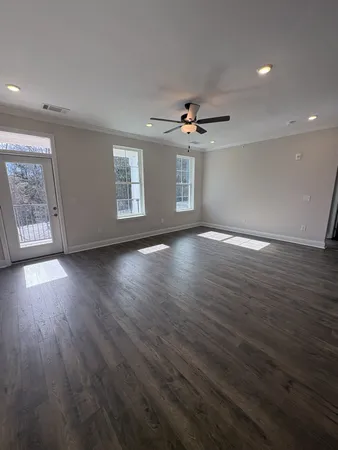 a view of kitchen center island wooden floor and living room view