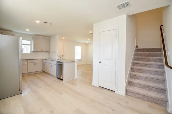 a view of kitchen with wooden floor and electronic appliances