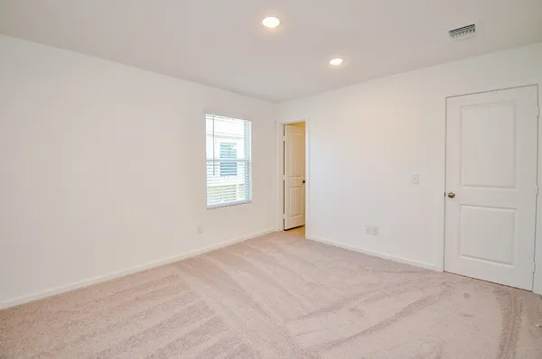 an empty room with windows and closet
