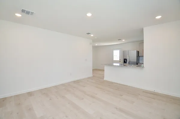 a view of a kitchen with a sink and a refrigerator
