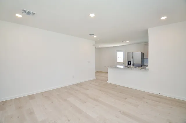 a view of a kitchen with a sink and a refrigerator
