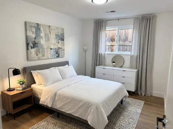 a bedroom with a bed and large window