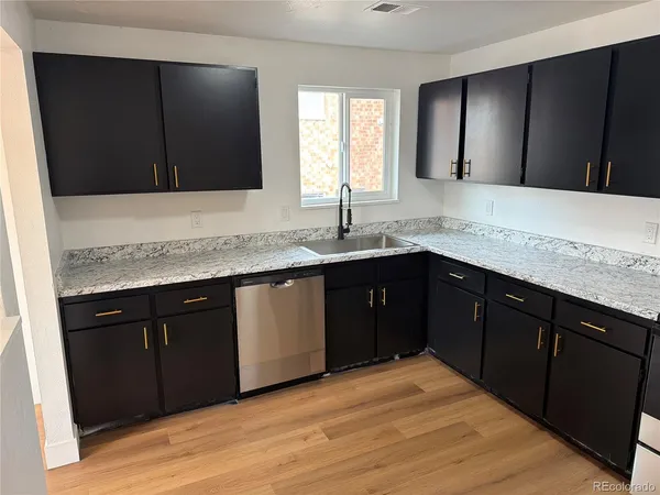 a kitchen with a sink and a mirror