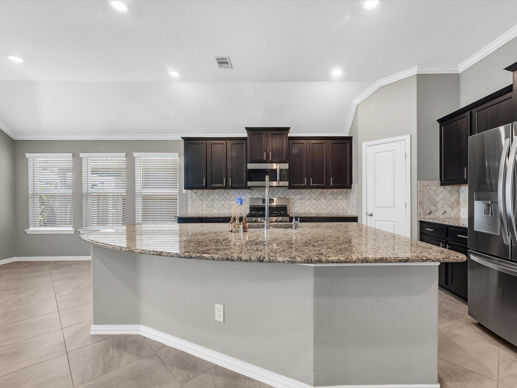 31120 Aspen Gate Trail Spring, TX 77386 - Photo 9 of 33 a kitchen with stainless steel appliances granite countertop a sink a stove a microwave a refrigerator and a granite counter tops