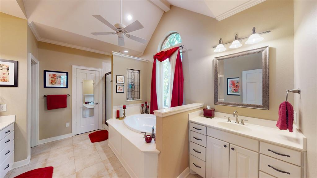 7451 County Road 1509 Athens, TX 75751 - Photo 11 of 36 a bathroom with a sink vanity and a mirror