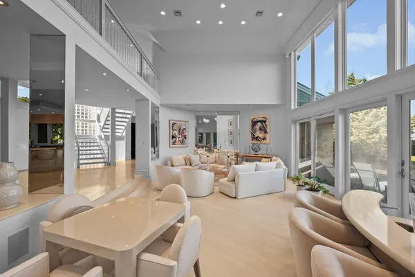 a living room with a bed and a large window