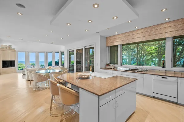a bathroom with a granite countertop sink mirror and toilet