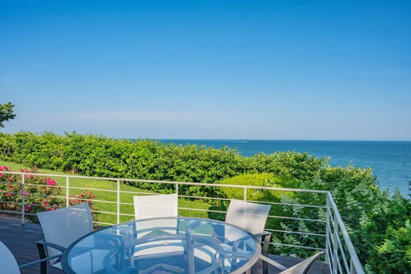 a living room with fireplace furniture and a large window