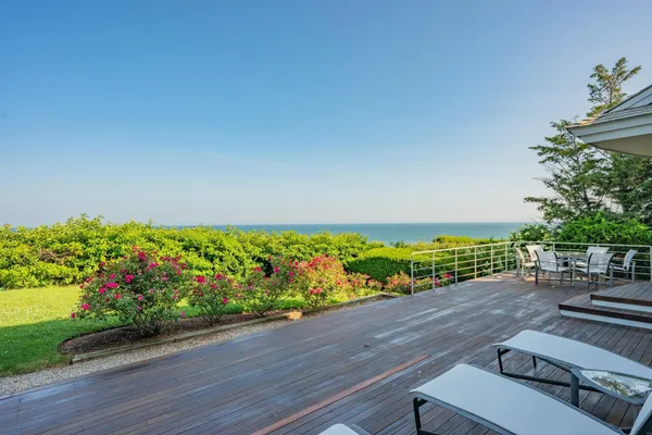 a living room with fireplace furniture and a large window