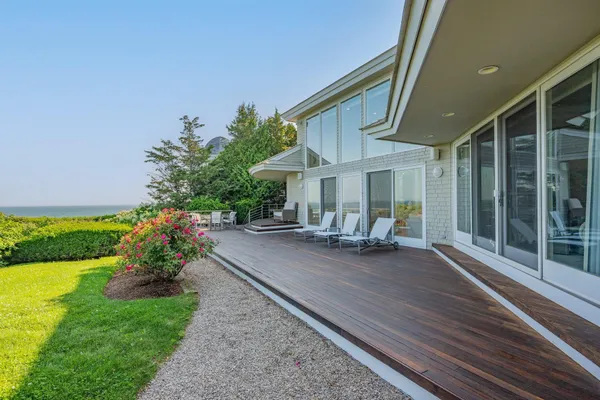 a living room with fireplace furniture and a large window