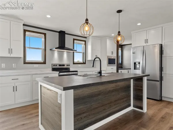 a kitchen with white cabinets and white appliances