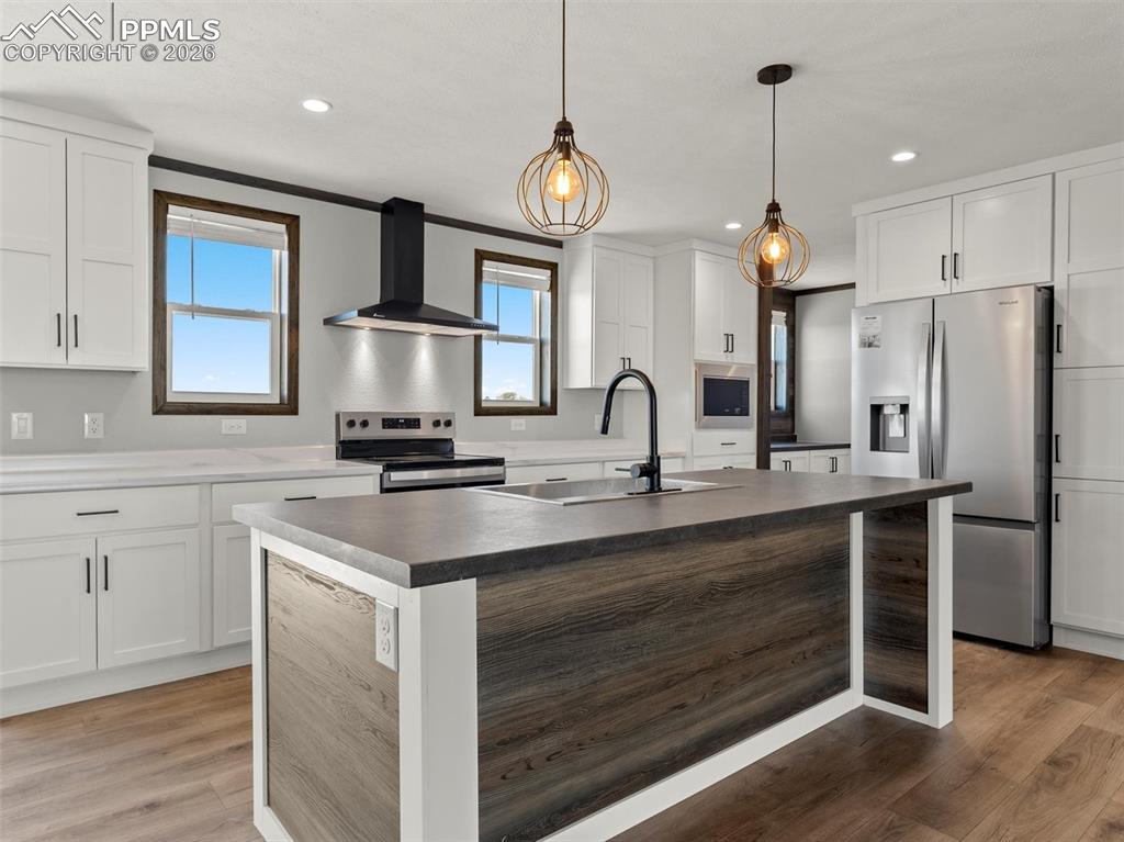 2820 East Ellicott Road South Calhan, CO 80808 - Photo 12 of 39 a kitchen with kitchen island granite countertop a sink stainless steel appliances and cabinets