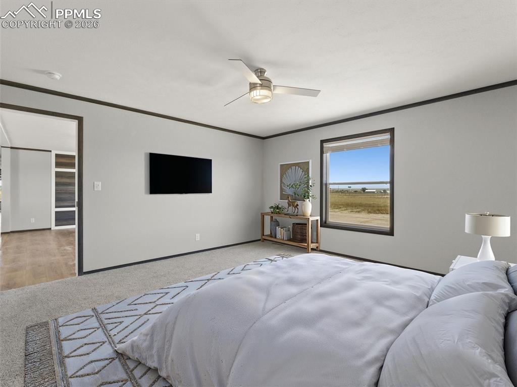 2820 East Ellicott Road South Calhan, CO 80808 - Photo 20 of 39 a bedroom with a bed and a flat screen tv