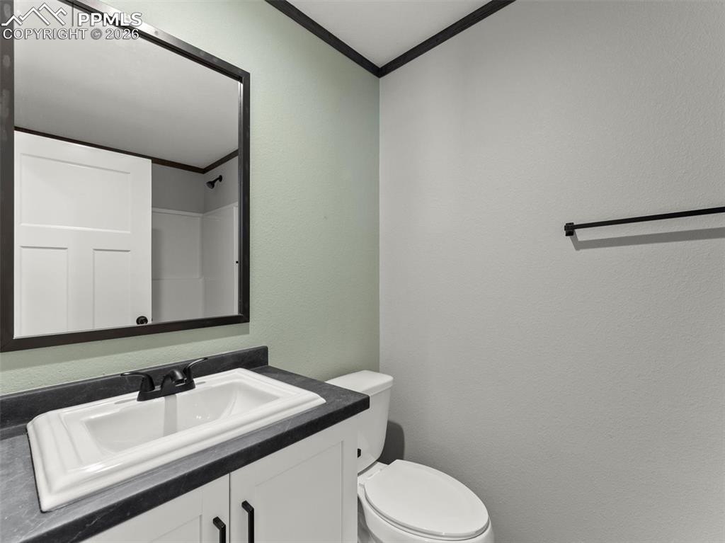 2820 East Ellicott Road South Calhan, CO 80808 - Photo 32 of 39 a bathroom with a sink and a toilet