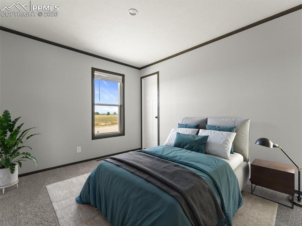 2820 East Ellicott Road South Calhan, CO 80808 - Photo 33 of 39 a bedroom with a large bed and a potted plant