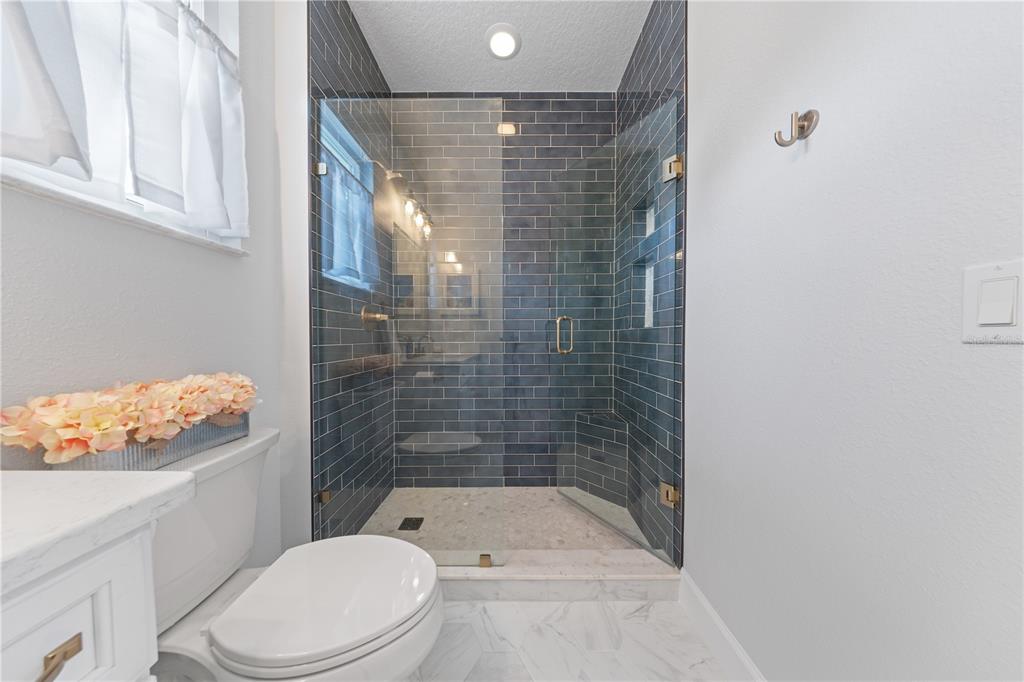 16948 Deer Island Road Tavares, FL 32778 - Photo 36 of 67 a bathroom with a shower a toilet and sink