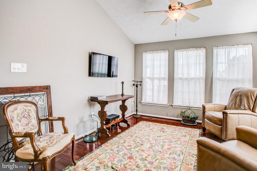 5036 Finsbury Road Baltimore, MD 21237 - Photo 14 of 34 a living room with furniture and a flat screen tv