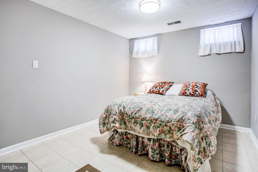 5036 Finsbury Road Baltimore, MD 21237 - Photo 22 of 34 a bedroom with a bed and a window