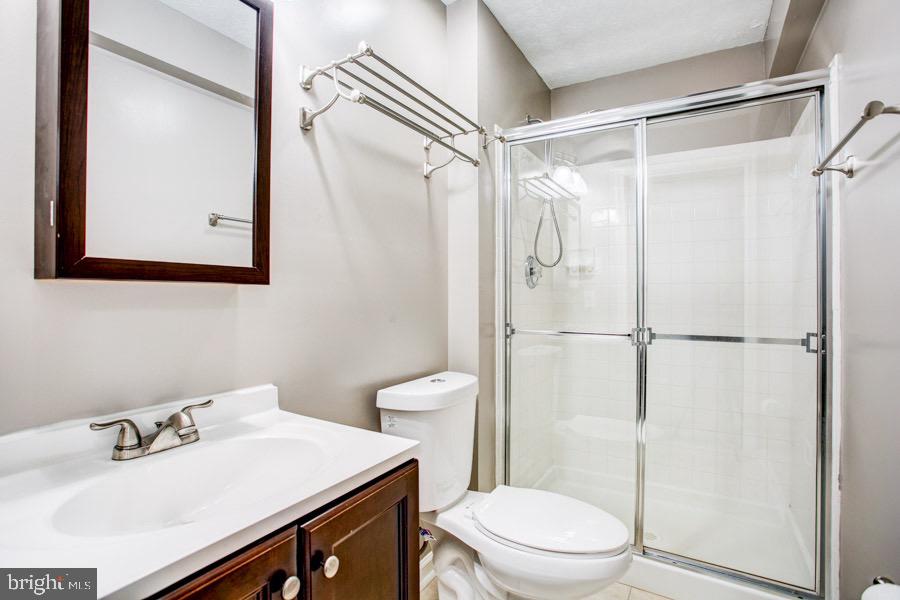5036 Finsbury Road Baltimore, MD 21237 - Photo 25 of 34 a bathroom with a sink vanity mirror and toilet