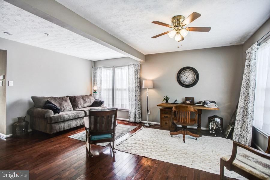 5036 Finsbury Road Baltimore, MD 21237 - Photo 3 of 34 a living room with furniture and a wooden floor