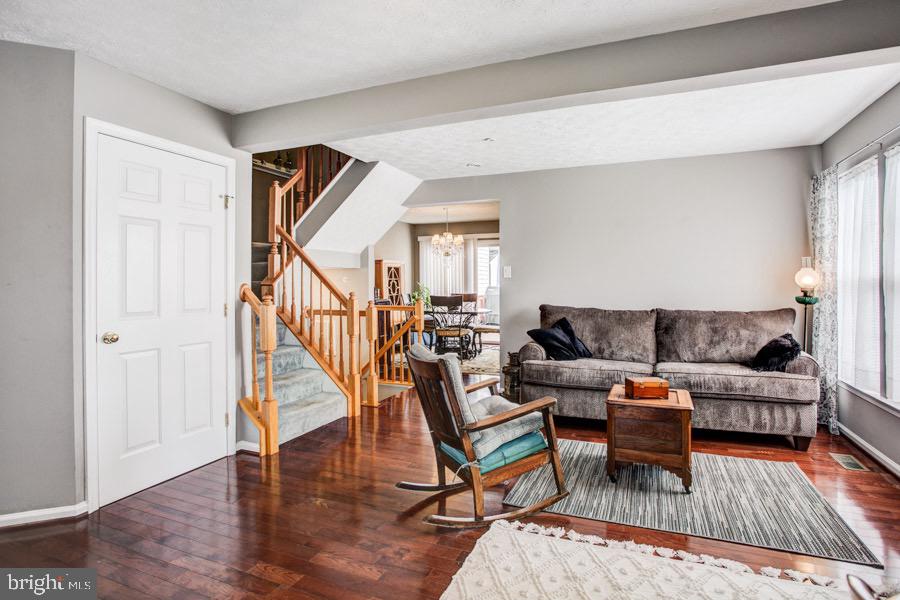 5036 Finsbury Road Baltimore, MD 21237 - Photo 5 of 34 a living room with furniture and a wooden floor