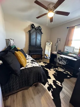 a bedroom with a bed and window