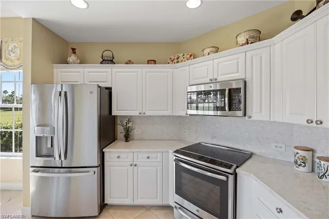 a kitchen with cabinets and stainless steel appliances