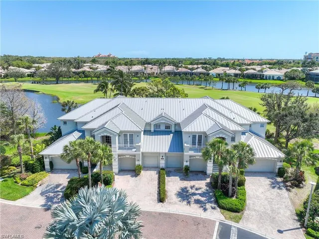 an aerial view of a house with outdoor space and lake view