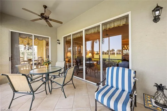 a view of a dining room with furniture large windows and wooden floor