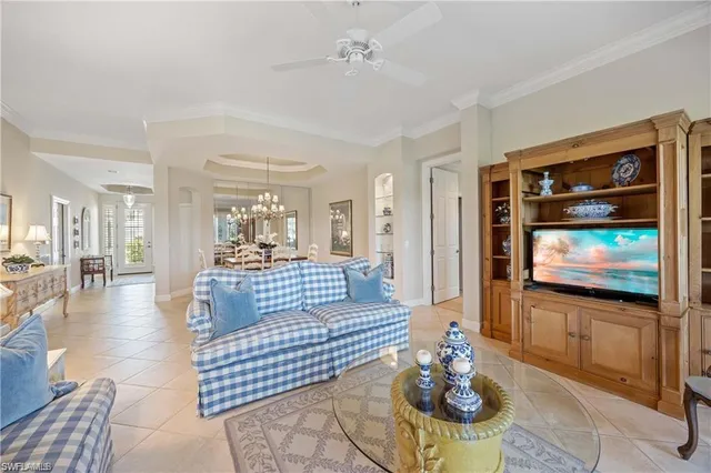 a living room with furniture and a floor to ceiling window