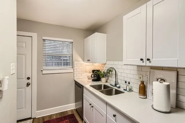 a kitchen with a sink cabinets and window