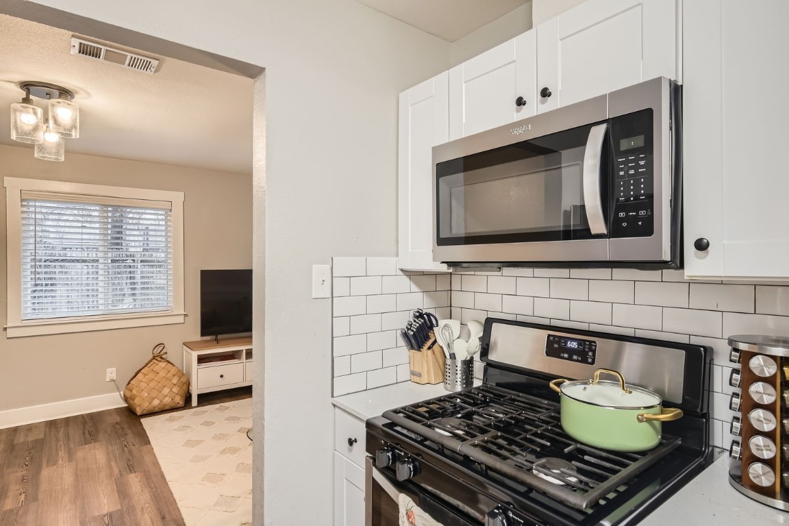 6108 Calmar Cove, Unit B Austin, TX 78721 - Photo 14 of 21 a kitchen with a stove and a microwave