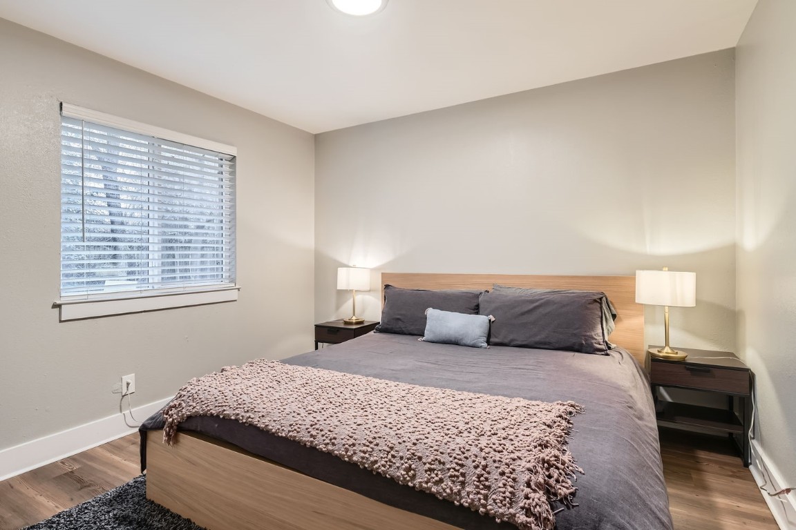 6108 Calmar Cove, Unit B Austin, TX 78721 - Photo 15 of 21 a bedroom with a large bed and a window