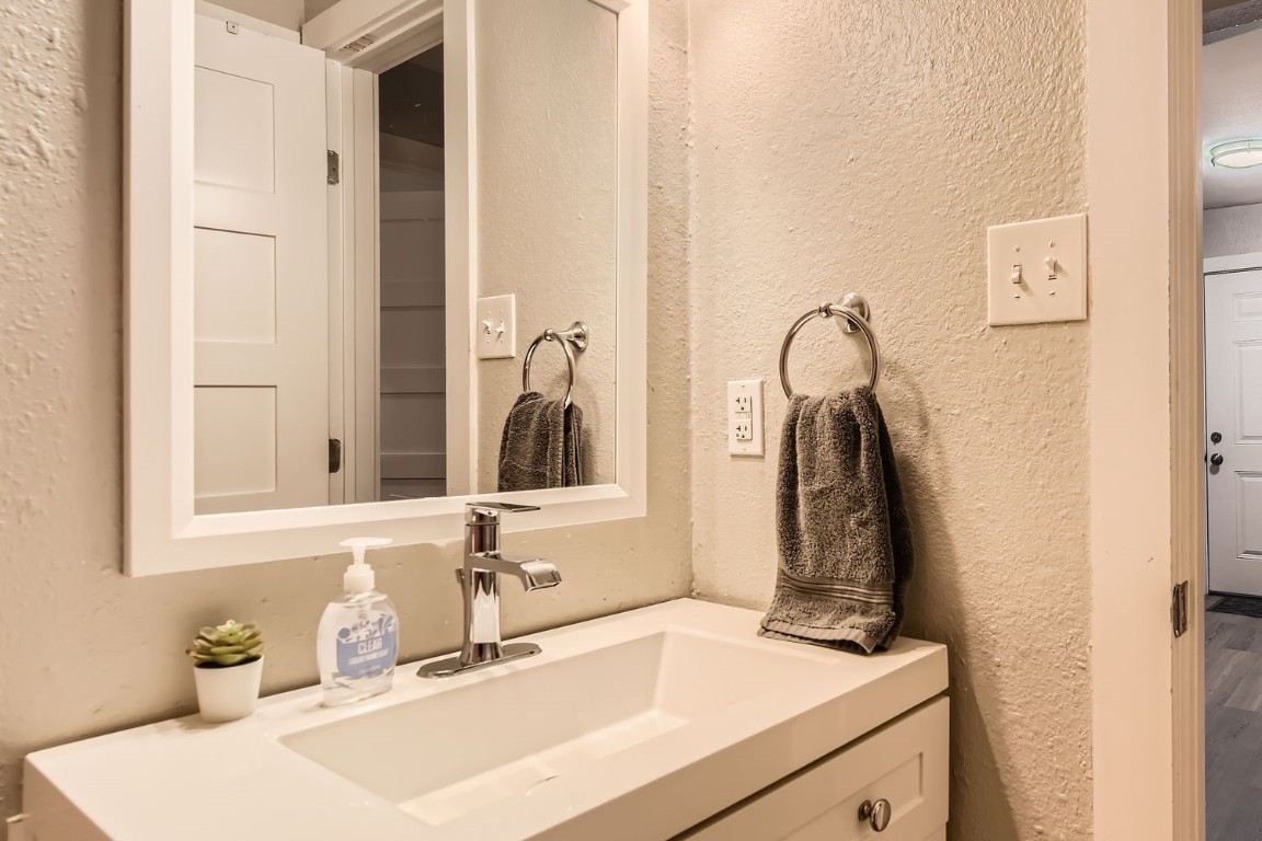 6108 Calmar Cove, Unit B Austin, TX 78721 - Photo 17 of 21 a bathroom with a sink and a mirror