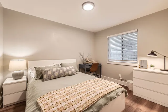 a bedroom with a bed and a window