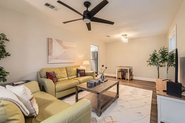 a living room with furniture and a potted plant