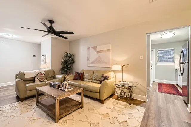 a living room with furniture and a lamp