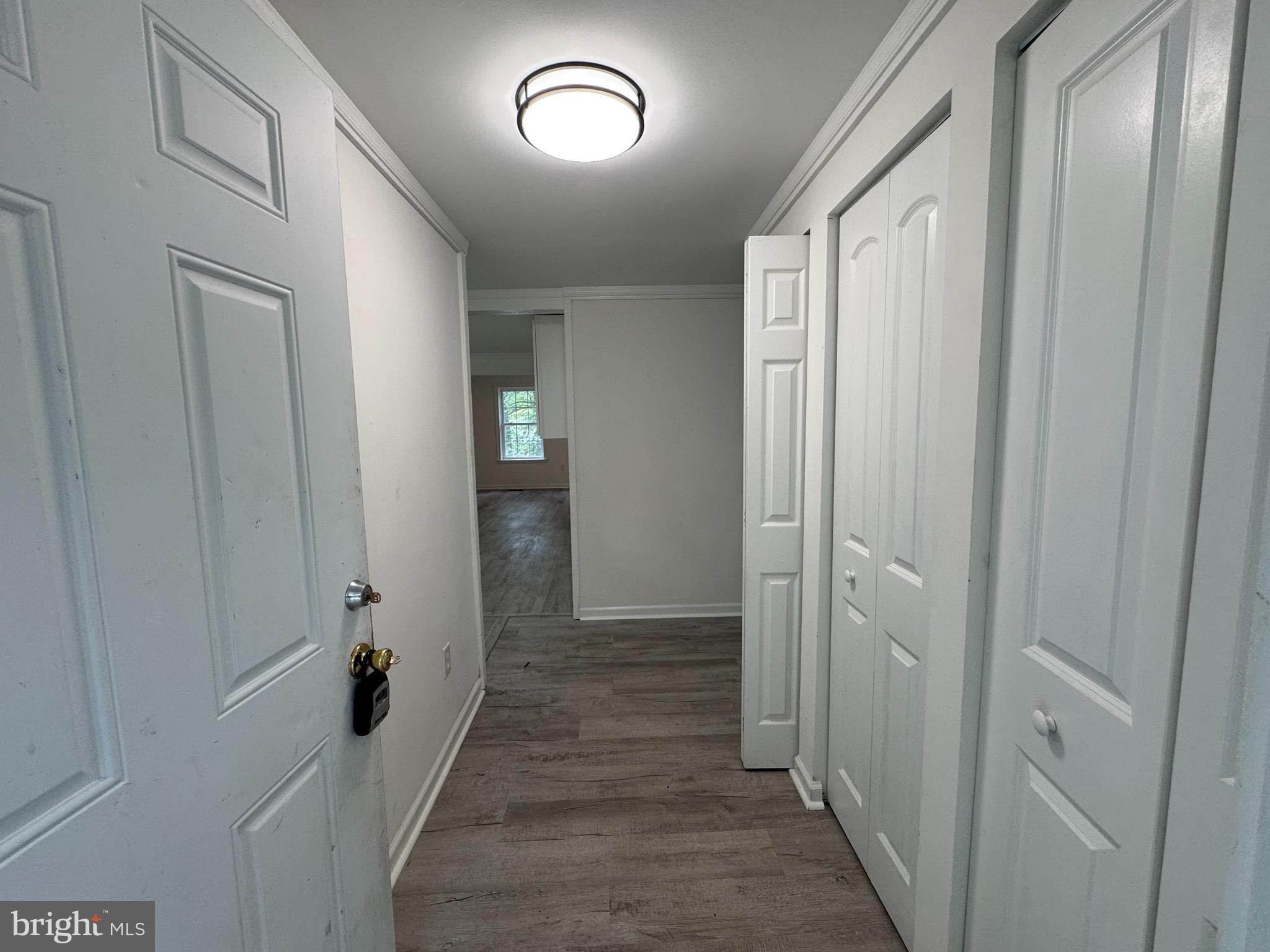 26374 Hill Road Ruther Glen, VA 22546 - Photo 15 of 31 a view of a hallway with wooden floor and closet area