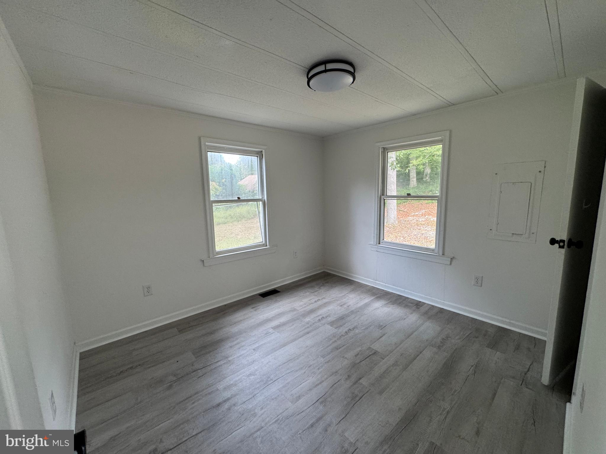 26374 Hill Road Ruther Glen, VA 22546 - Photo 17 of 31 a view of an empty room with wooden floor and a window