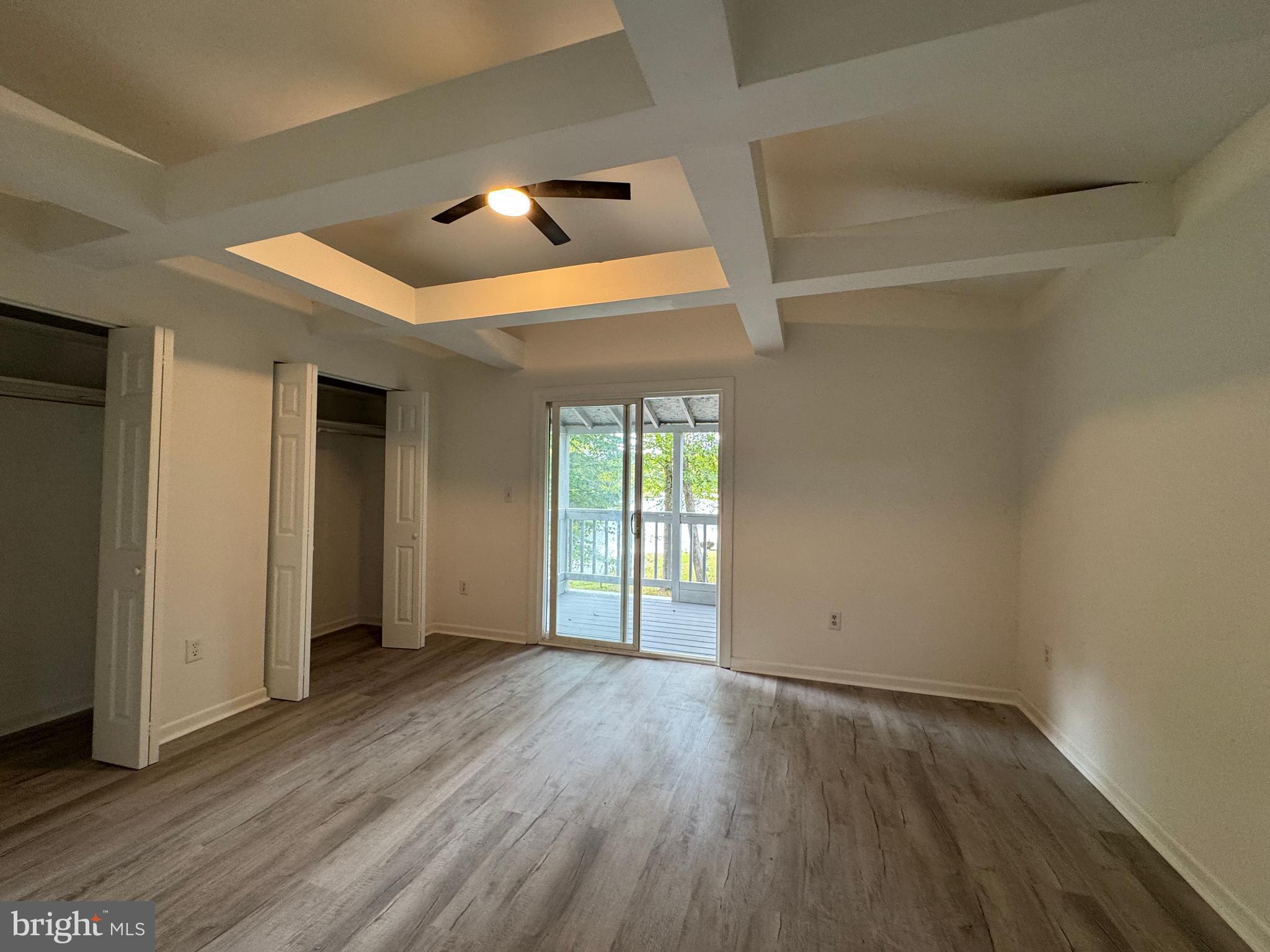 26374 Hill Road Ruther Glen, VA 22546 - Photo 21 of 31 an empty room with wooden floor and windows