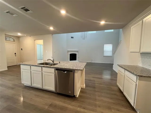 a kitchen with stainless steel appliances granite countertop a stove and a sink