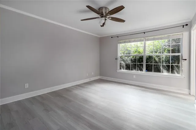 a view of room with window and ceiling fan