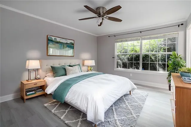 a spacious bedroom with a bed and a large window