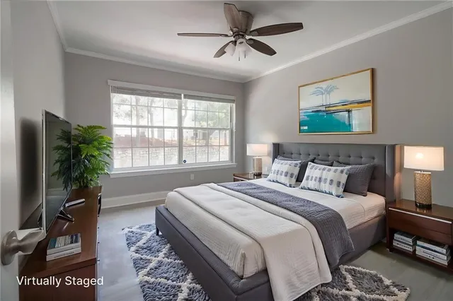 a spacious bedroom with a bed a couch and a potted plant