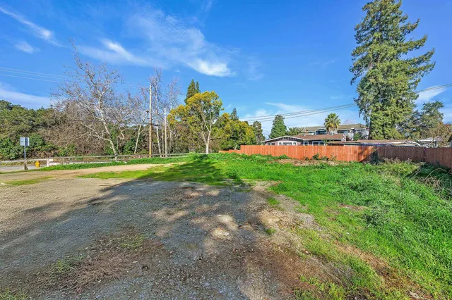 a view of yard with swimming pool and green space
