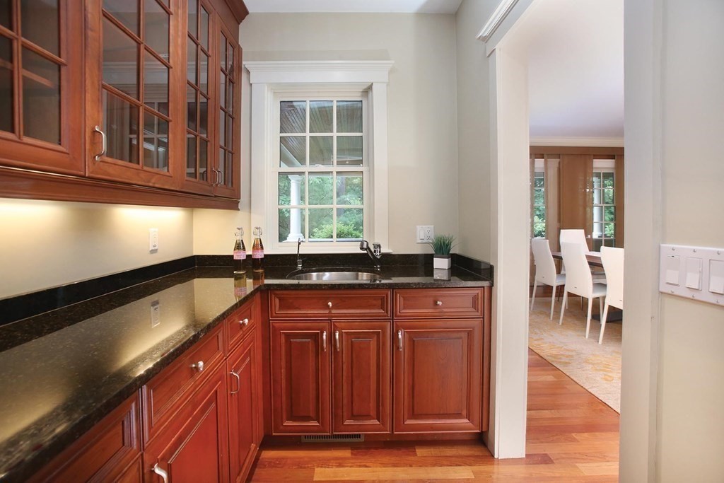10 Cutter's Bluff Weston, MA 02493 - Photo 11 of 34 a kitchen with granite countertop a sink and a stove